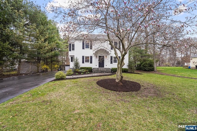 colonial house with a front yard and driveway