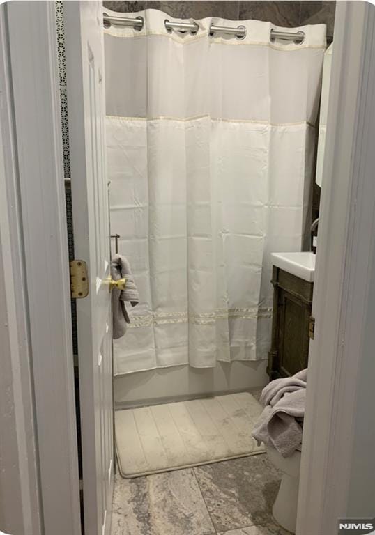 bathroom featuring vanity and curtained shower