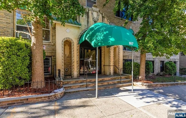 entrance to property featuring brick siding