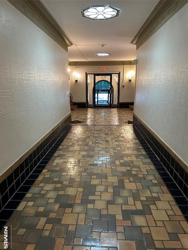 corridor with brick floor and ornamental molding