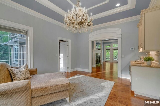 22 Nottingham Ct, Ringwood, NJ 07456 - living area with plenty of natural light, ornamental molding, light wood-type flooring, a tray ceiling, and baseboards