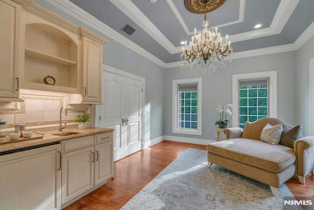 22 Nottingham Ct, Ringwood, NJ 07456 - sitting room with wood finished floors, a raised ceiling, a chandelier, ornamental molding, and baseboards