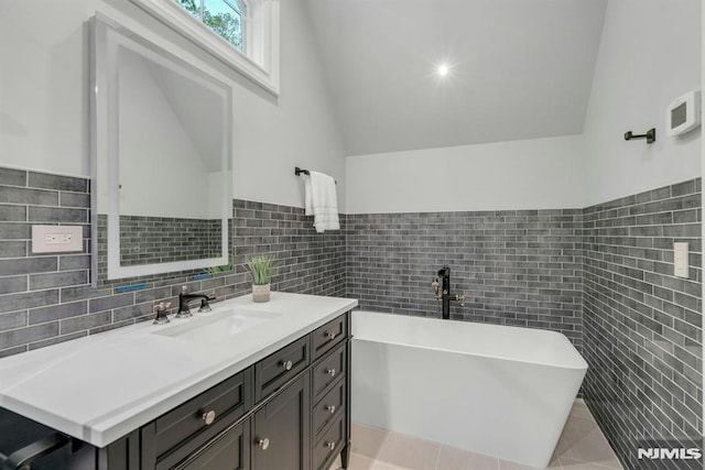 22 Nottingham Ct, Ringwood, NJ 07456 - full bath featuring tile walls, lofted ceiling, a freestanding bath, vanity, and tile patterned flooring
