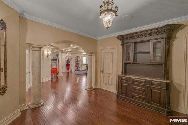 22 Nottingham Ct, Ringwood, NJ 07456 - hallway featuring ornate columns, arched walkways, crown molding, dark wood finished floors, and baseboards