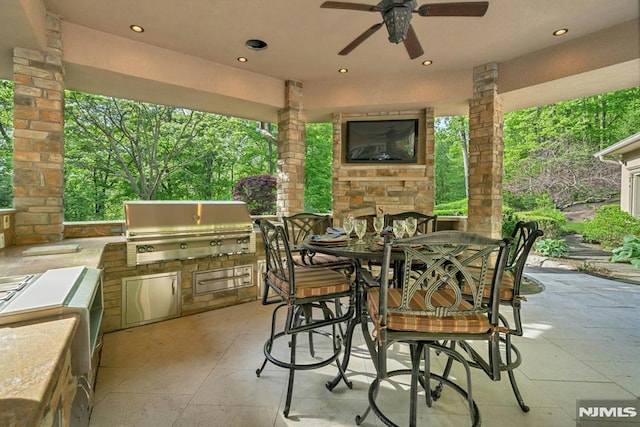 22 Nottingham Ct, Ringwood, NJ 07456 - view of patio with an outdoor stone fireplace, grilling area, outdoor dining area, exterior kitchen, and ceiling fan