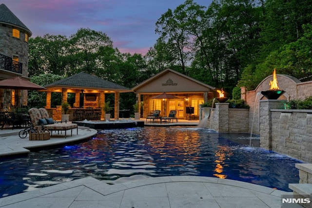 22 Nottingham Ct, Ringwood, NJ 07456 - pool at dusk with a storage structure, a gazebo, a patio, an outbuilding, and an outdoor pool