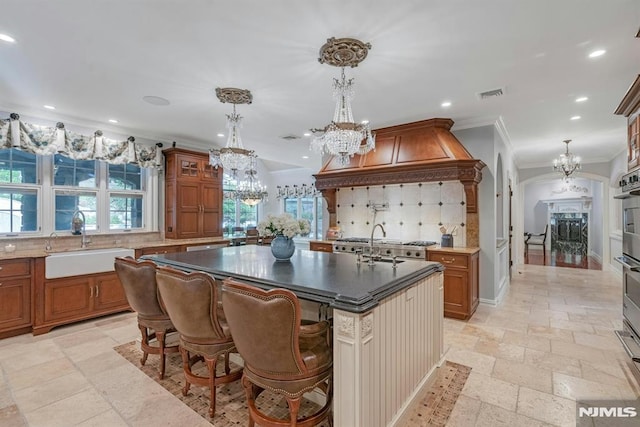 22 Nottingham Ct, Ringwood, NJ 07456 - kitchen with a sink, a chandelier, brown cabinets, recessed lighting, and stone tile floors