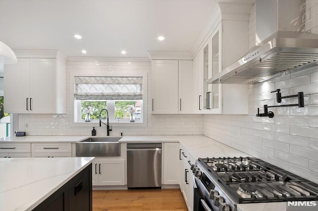 133 Graham Ter, Saddle Brook, NJ 07663 - kitchen with wall chimney exhaust hood, stainless steel appliances, white cabinets, backsplash, and recessed lighting