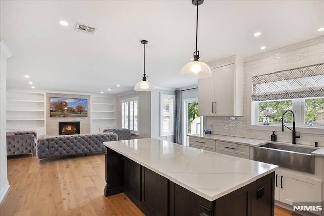 133 Graham Ter, Saddle Brook, NJ 07663 - kitchen featuring a center island, light wood-style flooring, white cabinets, open floor plan, and recessed lighting