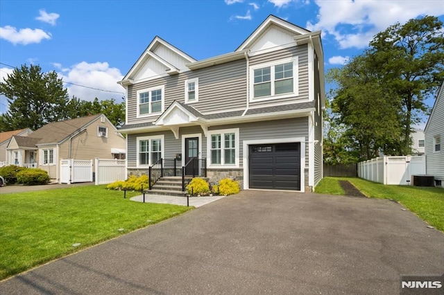 133 Graham Ter, Saddle Brook, NJ 07663 - view of front of home with stone siding, driveway, a garage, a gate, and board and batten siding