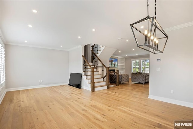 133 Graham Ter, Saddle Brook, NJ 07663 - unfurnished living room with stairs, crown molding, light wood-type flooring, recessed lighting, and a chandelier