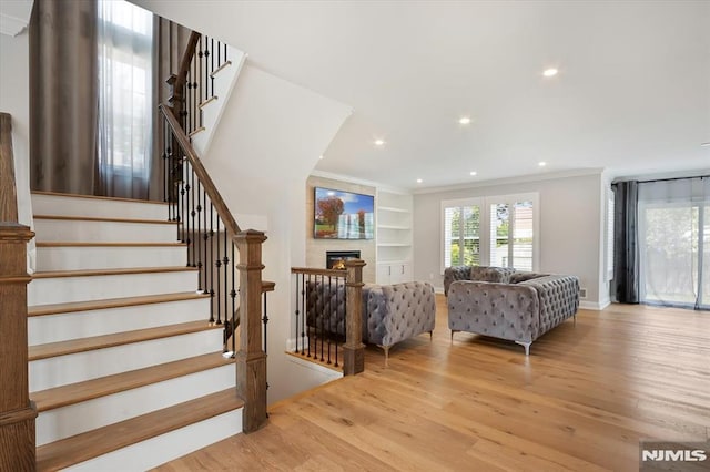 133 Graham Ter, Saddle Brook, NJ 07663 - staircase featuring wood finished floors, ornamental molding, recessed lighting, a fireplace, and built in shelves
