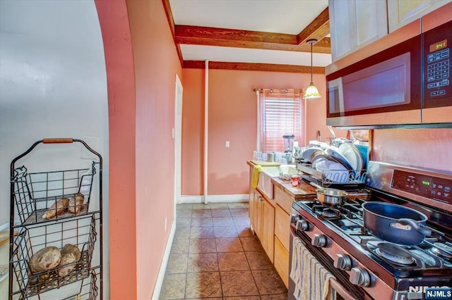27 Donaldson Ave, Rutherford, NJ 07070 - kitchen with beamed ceiling, stainless steel appliances, baseboards, and pendant lighting