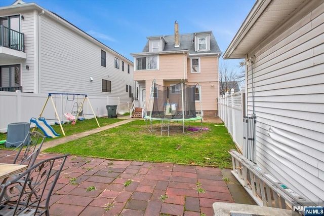 27 Donaldson Ave, Rutherford, NJ 07070 - back of property featuring a patio, a playground, a yard, and a trampoline