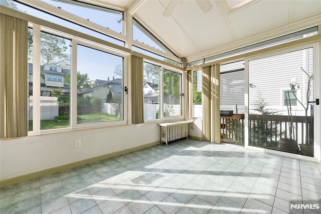 unfurnished sunroom featuring baseboards, lofted ceiling with beams, and radiator