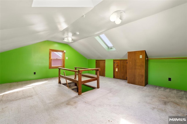bonus room featuring light carpet and lofted ceiling with skylight