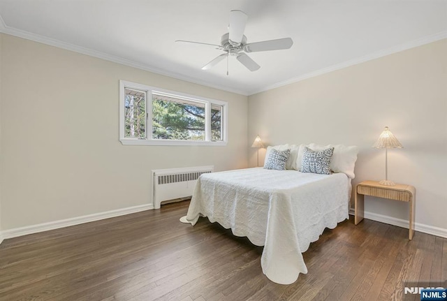 bedroom with dark wood-style flooring, baseboards, radiator heating unit, a ceiling fan, and ornamental molding