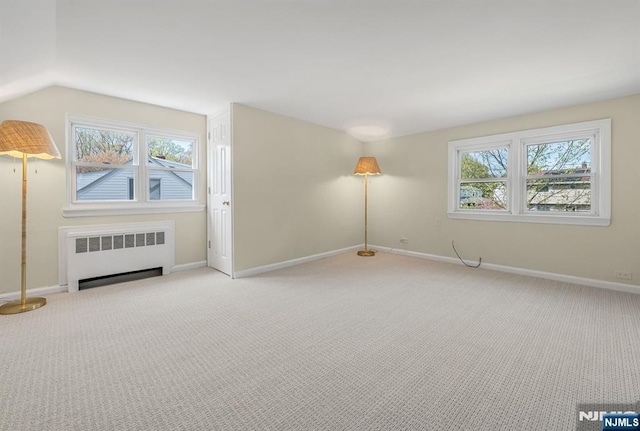 additional living space featuring radiator, baseboards, and carpet