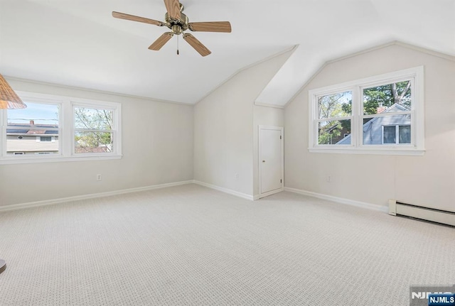 additional living space featuring vaulted ceiling, a healthy amount of sunlight, and light carpet