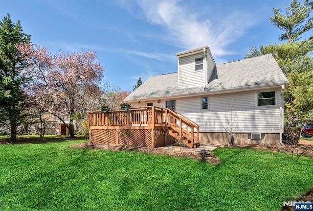 back of house with a lawn, stairs, roof with shingles, and a deck