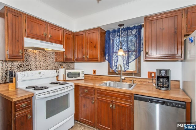 kitchen featuring under cabinet range hood, a sink, appliances with stainless steel finishes, and tasteful backsplash