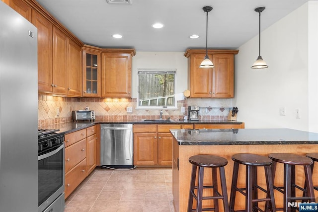 4 Colony Rd, Edgewater, NJ 07020 - kitchen featuring a breakfast bar, stainless steel appliances, and decorative backsplash