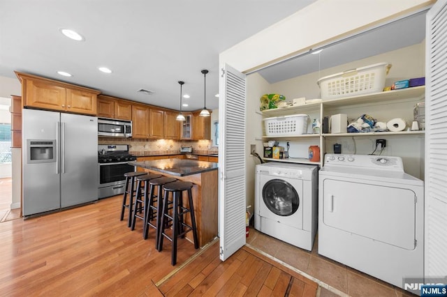 4 Colony Rd, Edgewater, NJ 07020 - clothes washing area featuring recessed lighting, visible vents, washer and clothes dryer, light wood-style floors, and laundry area