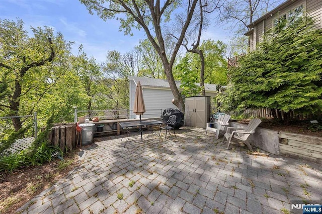 4 Colony Rd, Edgewater, NJ 07020 - view of patio / terrace featuring a storage shed, an outbuilding, outdoor dining space, and a fenced backyard