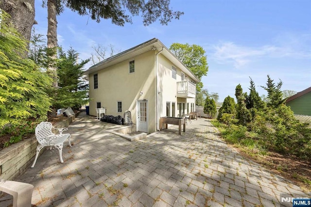 4 Colony Rd, Edgewater, NJ 07020 - back of property featuring stucco siding, a patio area, and a balcony