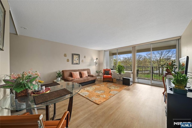 6 Horizon Rd Unit 206, Fort Lee, NJ 07024 - living area featuring wood finished floors, a textured ceiling, and floor to ceiling windows