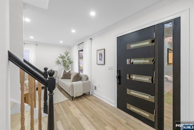 foyer entrance featuring recessed lighting, light wood-style flooring, visible vents, and plenty of natural light