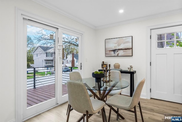 dining space featuring plenty of natural light, light wood-style floors, and ornamental molding
