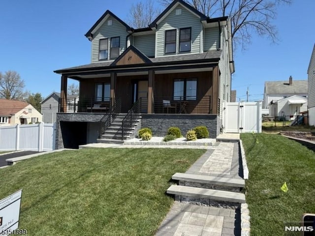 view of front of property with a gate, stairway, a front lawn, and fence