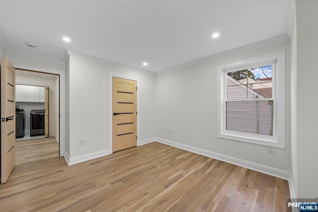 unfurnished room with separate washer and dryer, baseboards, light wood-style floors, and recessed lighting