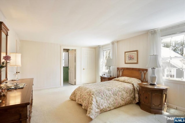 carpeted bedroom with baseboards and multiple windows