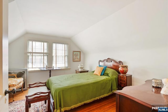 bedroom featuring vaulted ceiling and wood finished floors