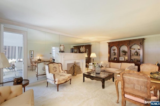 living area with carpet floors and ornamental molding