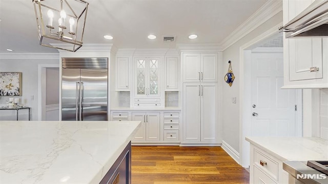 19 Merrill Dr, Mahwah, NJ 07430 - kitchen featuring stainless steel built in refrigerator, white cabinetry, crown molding, wood finished floors, and recessed lighting