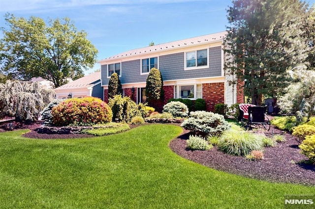 19 Merrill Dr, Mahwah, NJ 07430 - front of property with brick siding, a front yard, and a garage