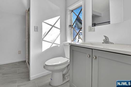 14 Harvey Rd, West Milford, NJ 07421 - bathroom with baseboards, toilet, and vanity