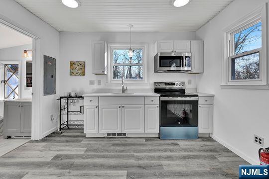 14 Harvey Rd, West Milford, NJ 07421 - kitchen with stainless steel appliances, visible vents, a sink, and a healthy amount of sunlight