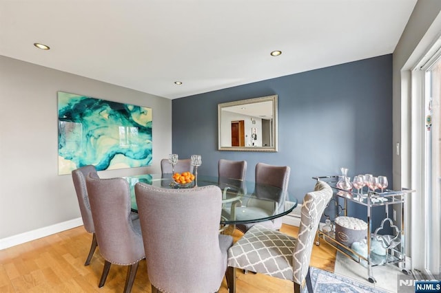 dining space with recessed lighting, baseboards, and wood finished floors
