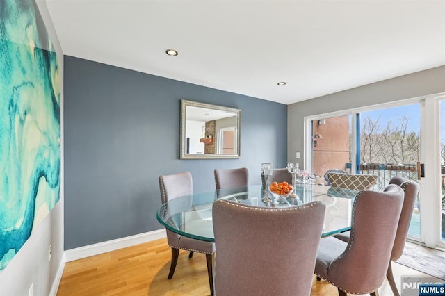 dining room featuring baseboards, recessed lighting, and wood finished floors