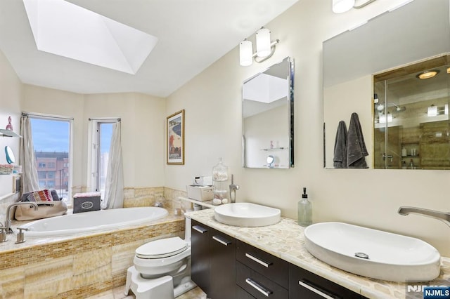 bathroom with a skylight, a sink, a bath, and a stall shower