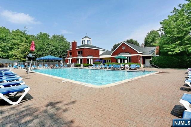 community pool featuring a patio and fence