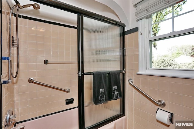 full bath featuring shower / bath combination with glass door