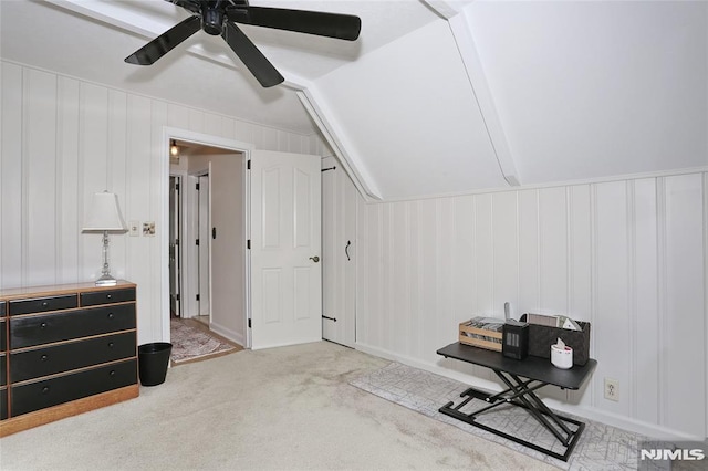 bonus room featuring carpet flooring, a ceiling fan, vaulted ceiling, and a decorative wall