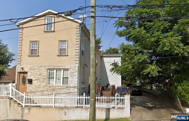 247-249 Sussex St, Paterson, NJ 07503 - view of front of property with brick siding and fence private yard