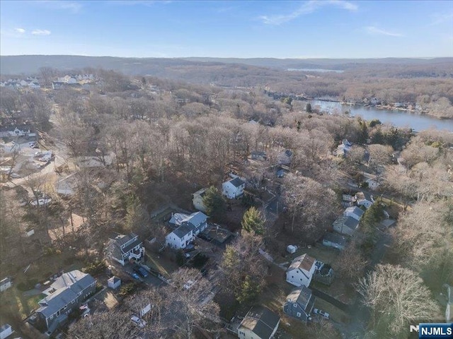 aerial view with a wooded view and a water view