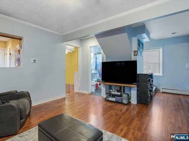 living room with ornamental molding, baseboards, wood finished floors, and a baseboard radiator
